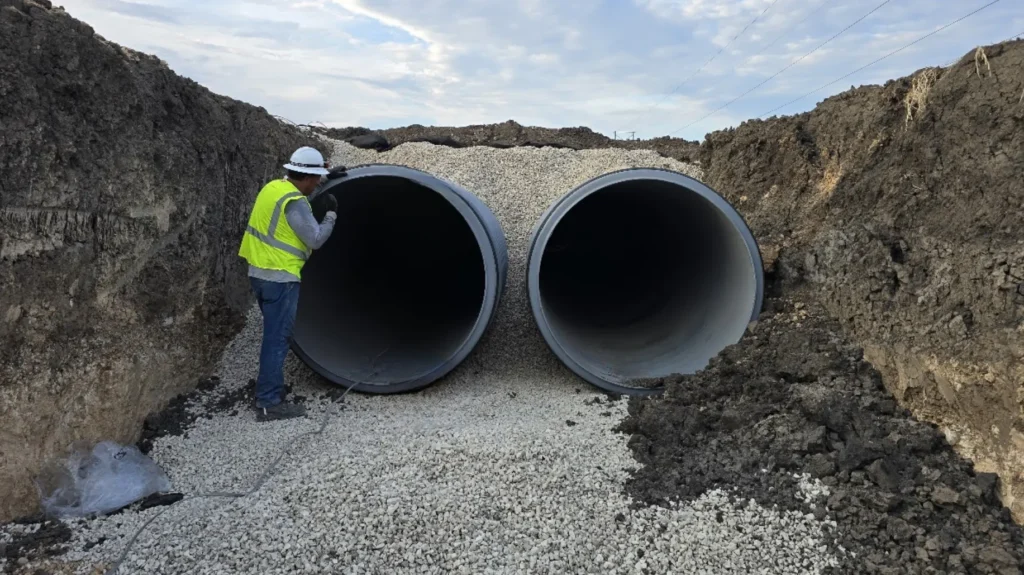 Corrugated polypropylene pipe San Marcos — TDR PRO 18–60 in pipe being installed in a trench at Whisper South Business Park, San Marcos, Texas