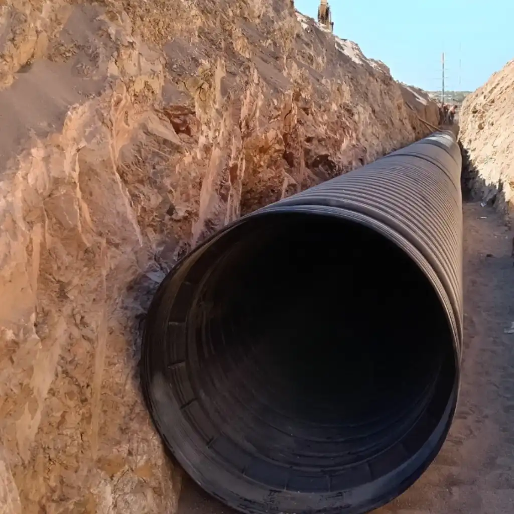 Athletic field drainage Fort Worth — crew installing TDR ULTRA corrugated HDPE drainage pipe across the North Crowley practice fields, Fort Worth, Texas