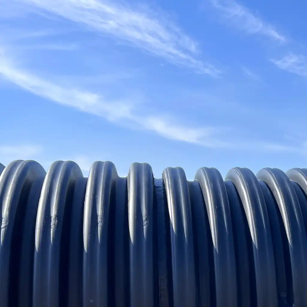 Hotel site drainage Nacogdoches — TDR ULTRA HDPE pipe set beneath concrete parking and curb-and-gutter at the Nacogdoches hotel development, TX