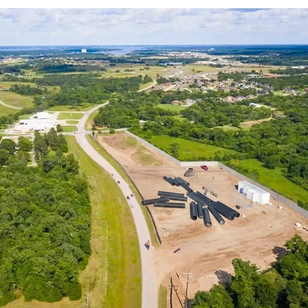Industrial site drainage Montgomery — crew installing TDR ULTRA corrugated HDPE drainage pipe at the Deanco Lone Star Parkway development, Montgomery, Texas