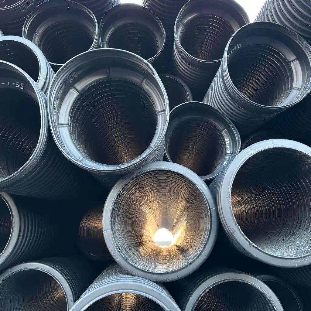Industrial yard drainage Baytown — crew installing TDR ULTRA corrugated HDPE drainage pipe across the active TGS yard, Baytown, Texas